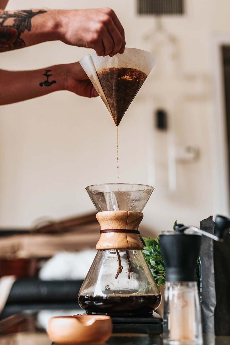 los angeles person filtering coffee in funnel hourglass